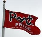 Waving red flag reads "Port Pride"